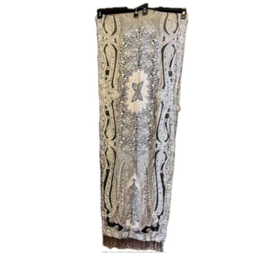 Long grey, black, and white knit scarf with tassels.